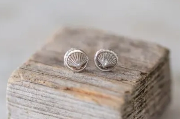 Discover the joy of a Norfolk beach with these sterling silver mini studs, featuring a scallop shell design made from melted silver snippets.