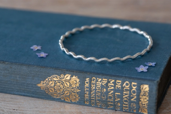 Handmade sterling silver High Tide Wave Bangle with flowing curves—crafted with care and inspired by Norfolk’s wild coastline.