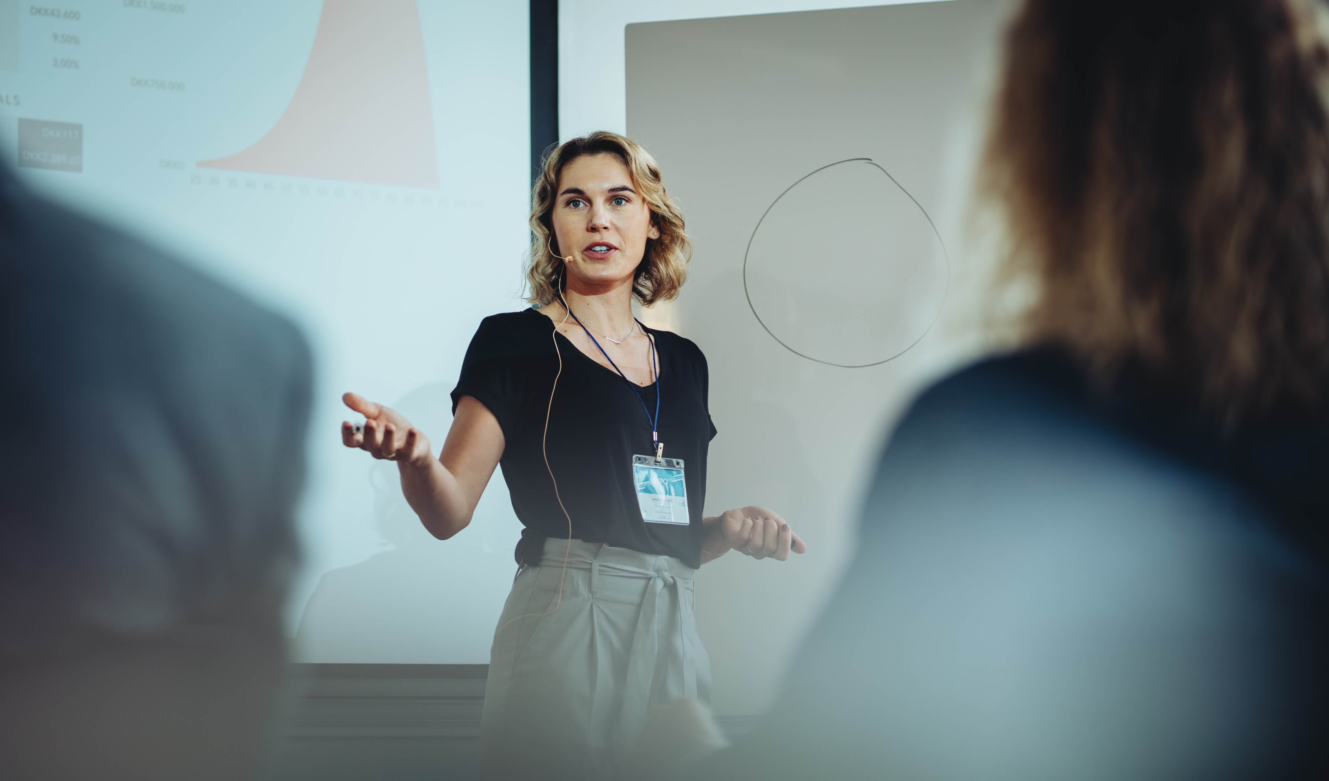 Woman presenting Performitiv data to a crowd