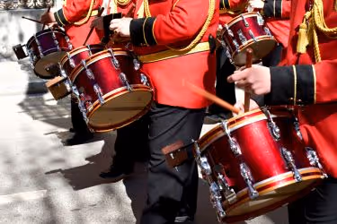 Orchestra parading with drums