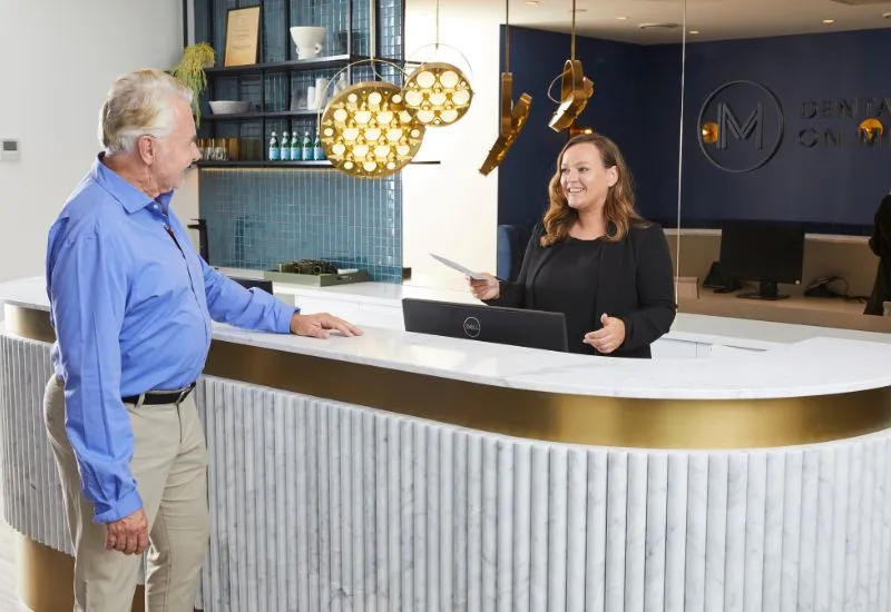 A patient discusses dental implants payment plans at Dental Implants on Miller