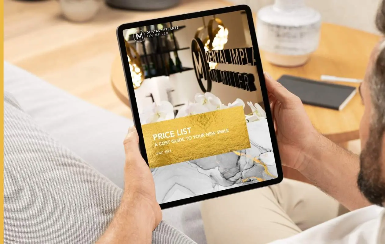 Person reading Dental Implants on Miller's price list  on iPad.