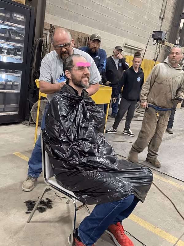 Adam Duggins getting his head shaved