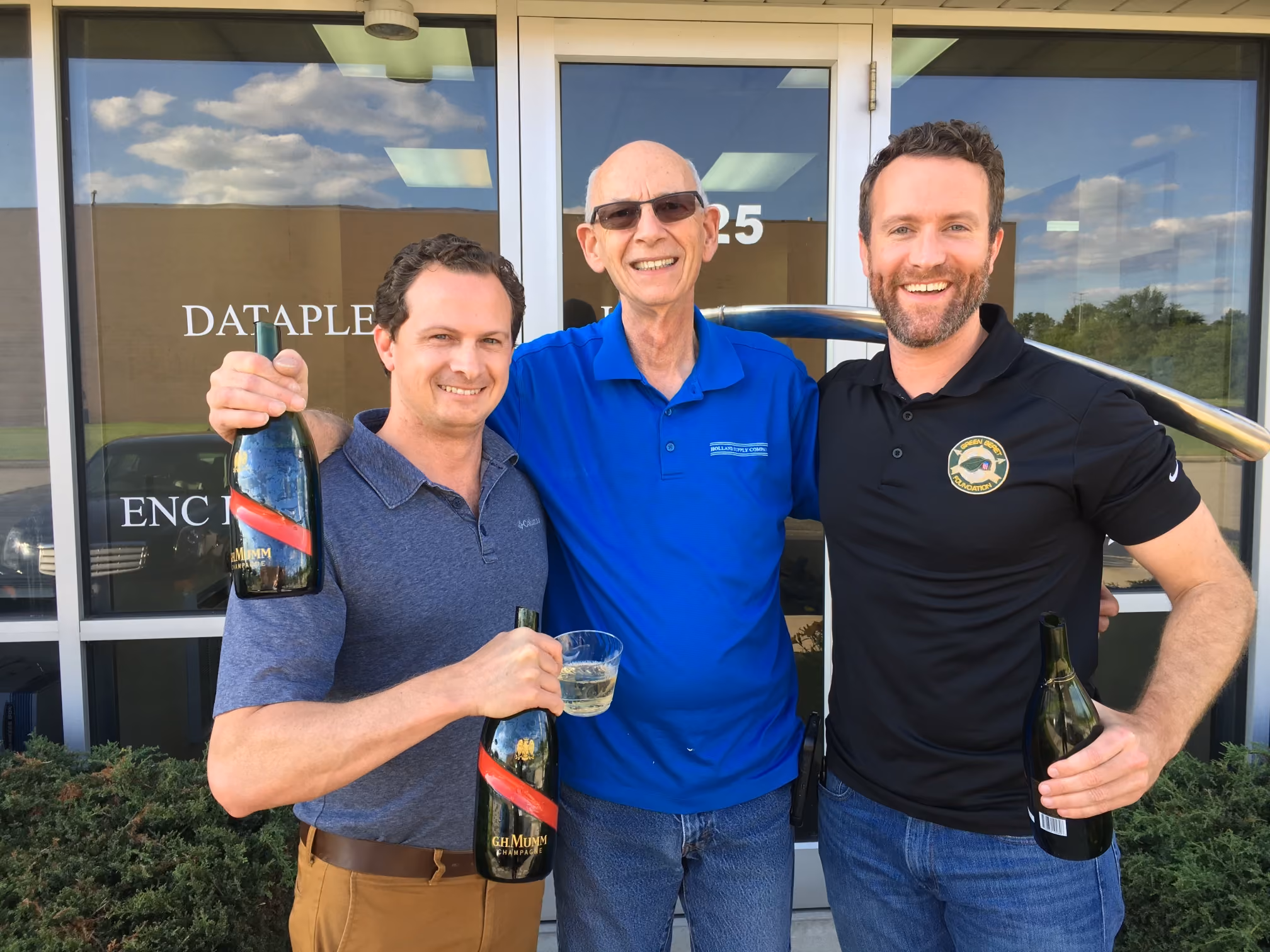 Danny Fields, Steve Reis, Craig Wathen celebrating the acquisition
