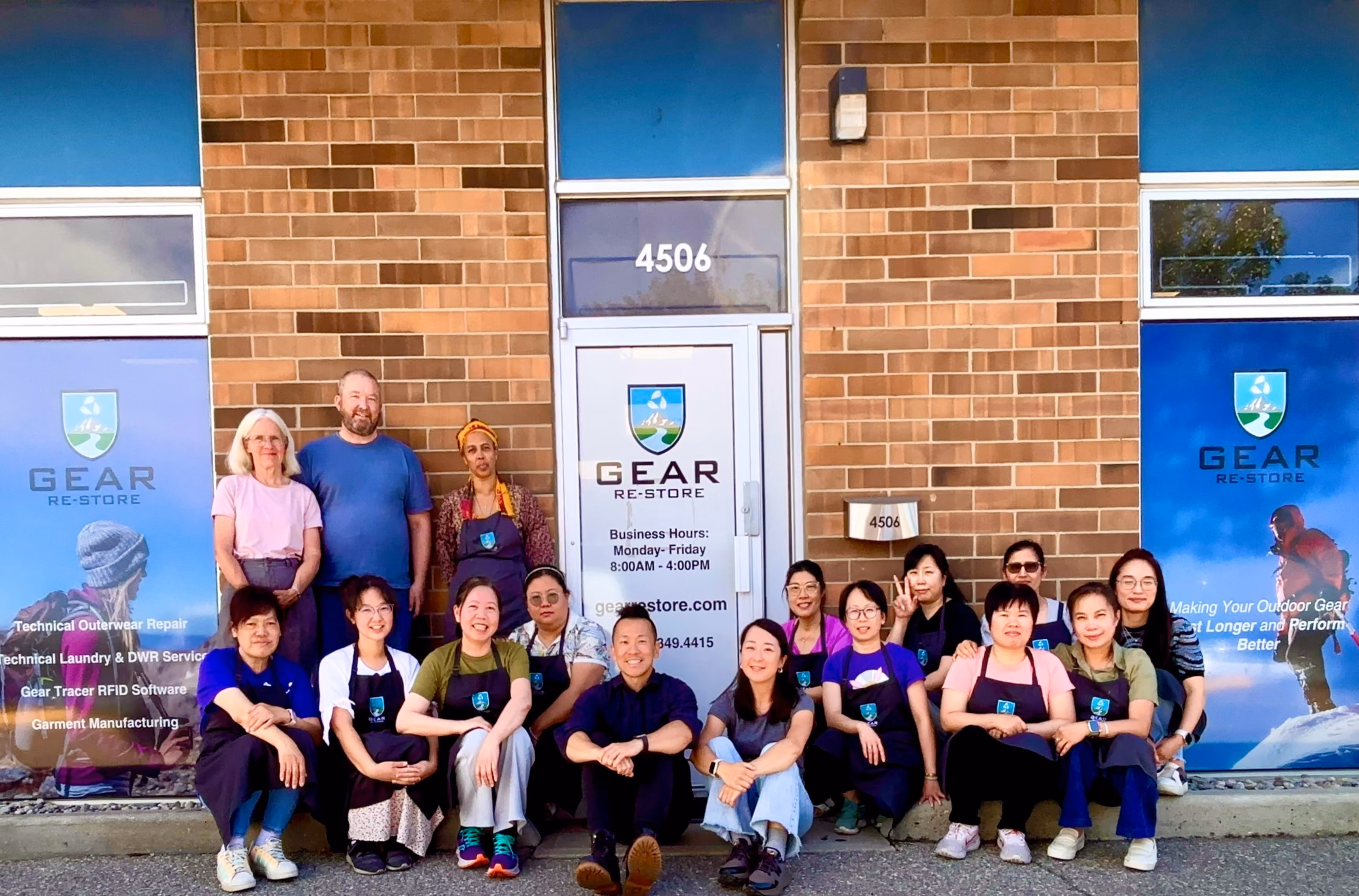 Jesus and team in front of the door's company