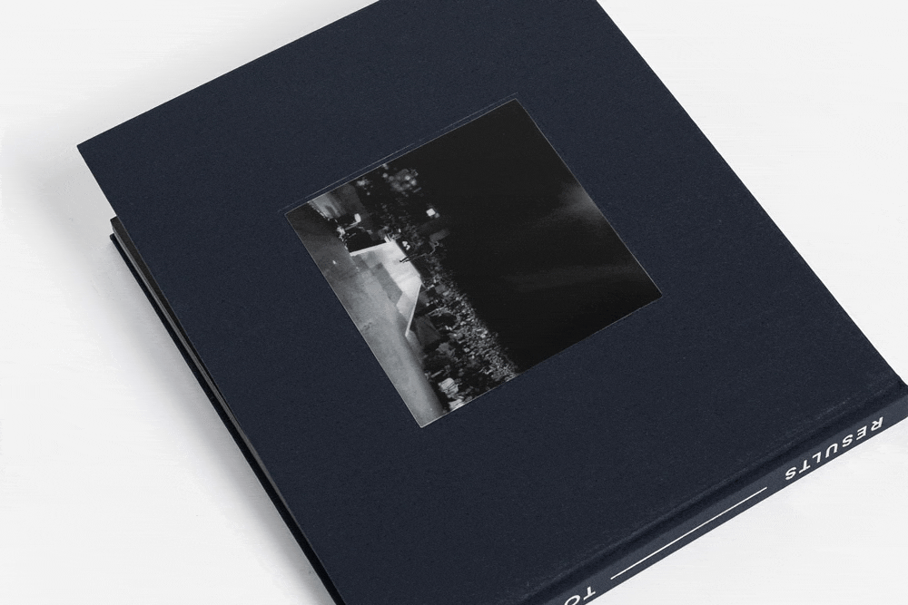 Coffee table book book titled 'RESULTS' with a 3D lenticular image of Tony Jeary walking across the stage in front of a large audience.