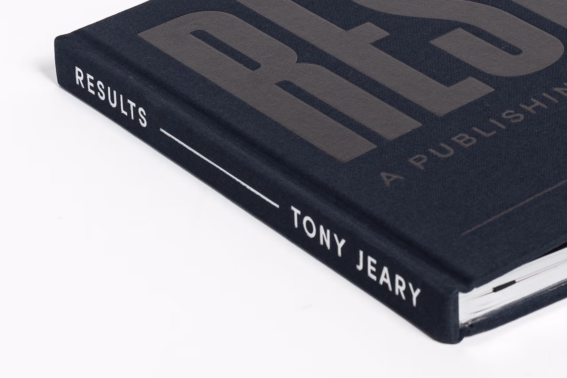 Close-up of a black hardcover coffee table book titled 'RESULTS' by Tony Jeary with silver embossed text on the spine.