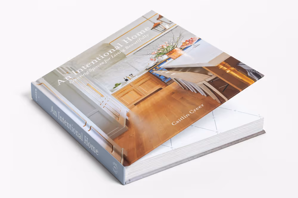 Coffee table book book titled 'An Intentional Home: Creating Spaces for Living Beautifully' by Caitlin Creer, showing a kitchen and dining area on the cover.