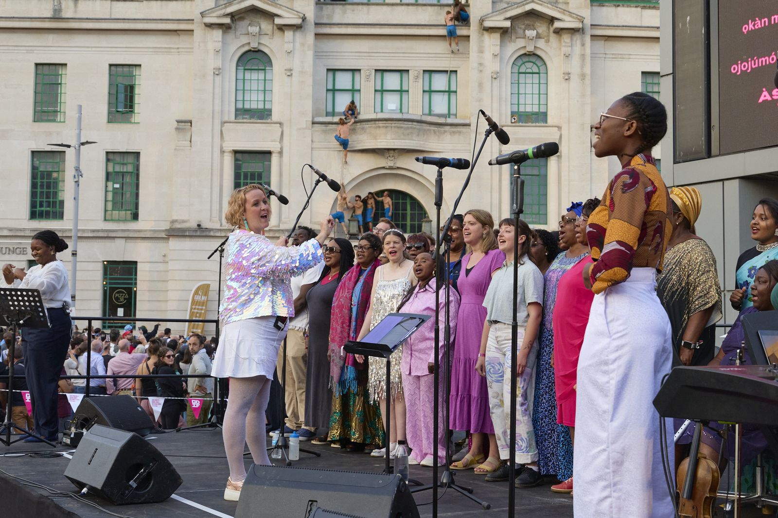 The choir performing outdoors in Woolwich at Greenwich and Docklands International Festival