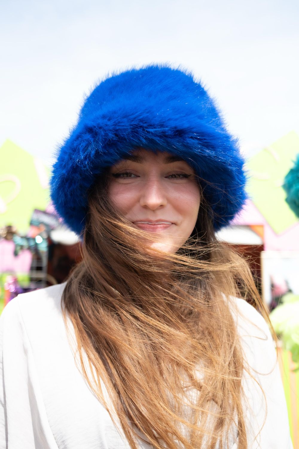 Portrait of a choir member in a blue fur hat at a festival