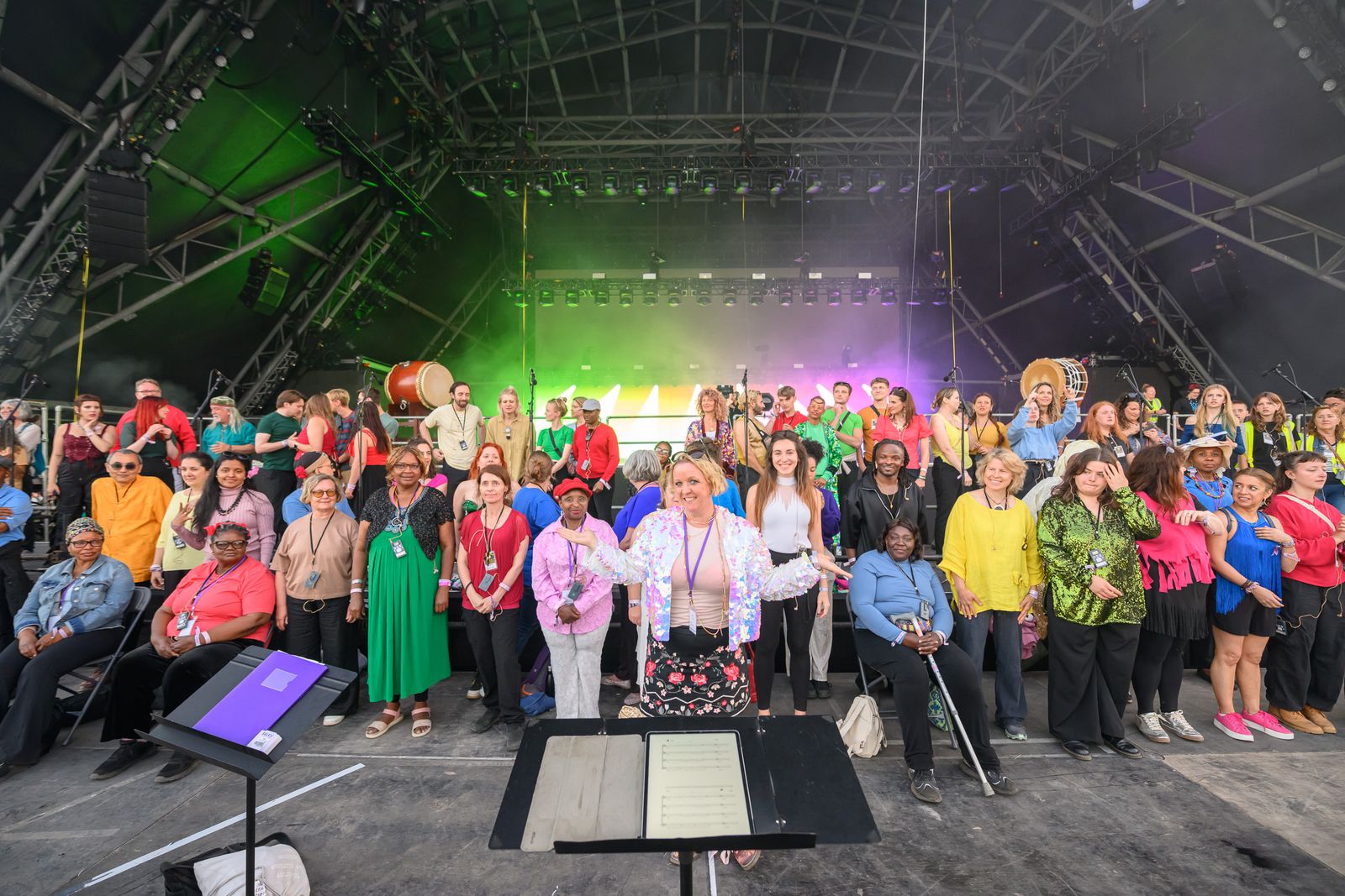 Citizens of the World Choir on stage with conductor Becky Dell at Glastonbury
