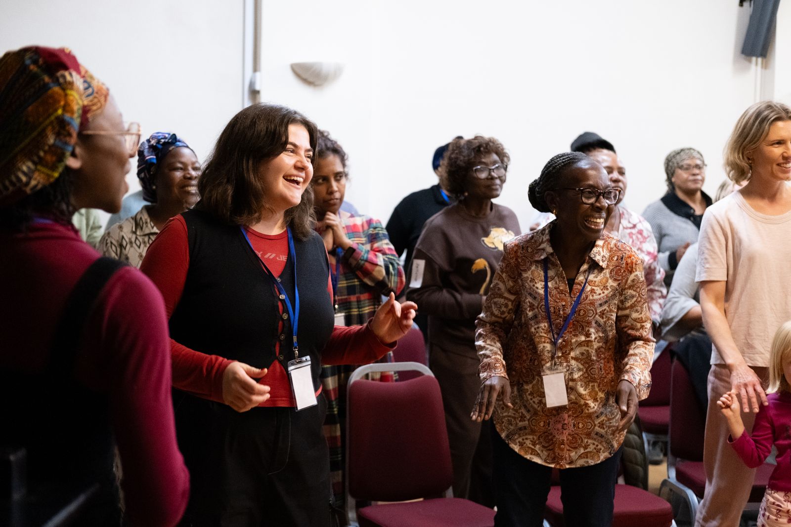 Choir members laughing together at a rehearsal