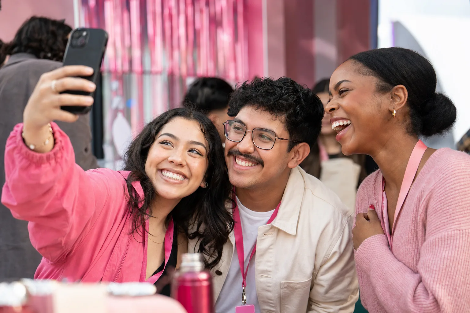 An employee taking a team photo at a company event to share on social media