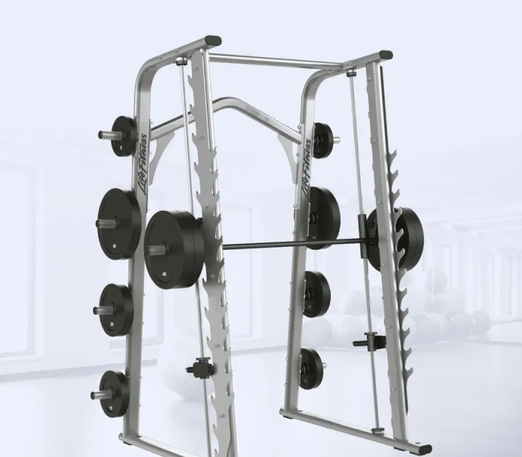 Smith machine with weight plates in a bright fitness studio.