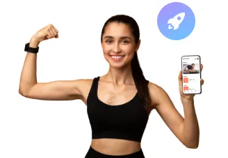 Smiling woman in black workout attire flexing arm muscle and holding a smartphone showing a fitness app with a rocket icon above.