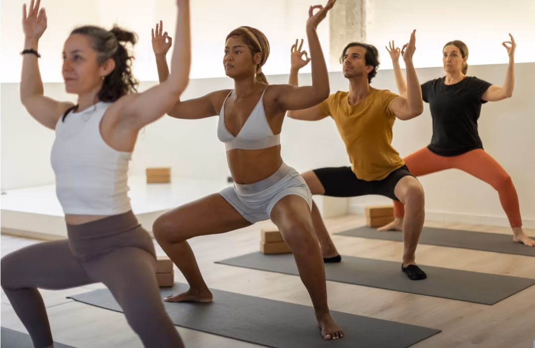 Calm yoga studio interior with natural light and rolled mats