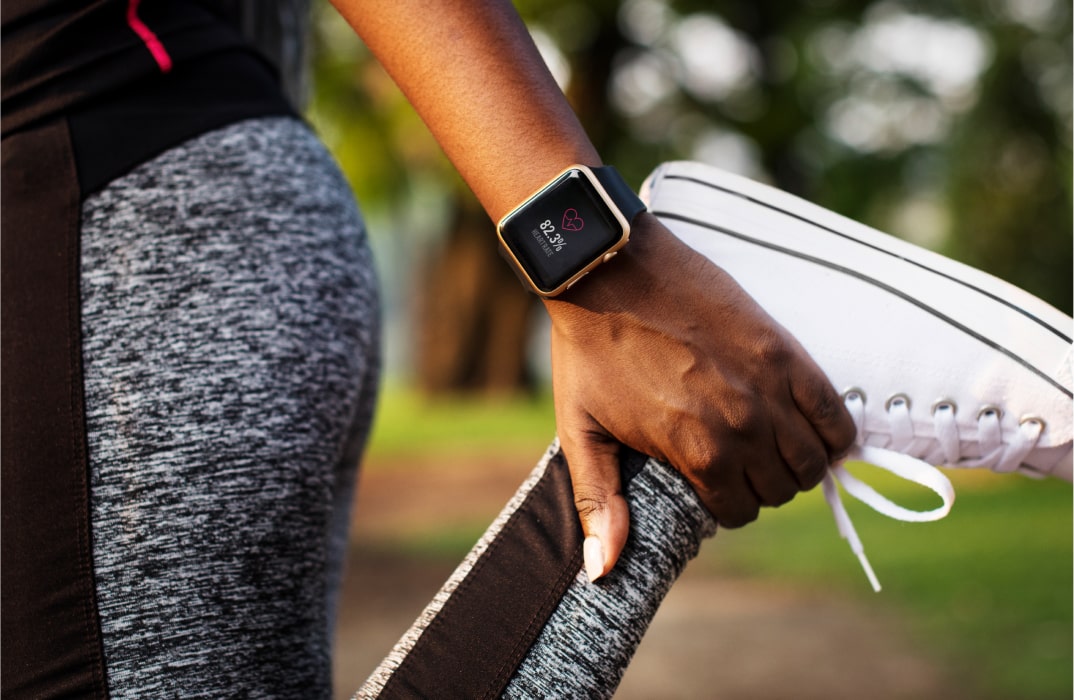 Close-up of a smartwatch displaying heart rate data, highlighting the importance of wearable device integration in fitness apps.
