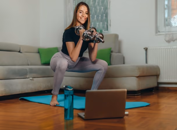fitness coach doing workout at home while teaching online