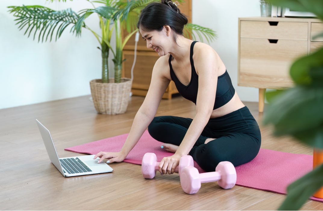 A user following a FitBudd workout on their phone while performing exercises.
