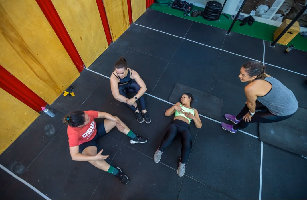 fitness coaches and trainers resting after workout in gym