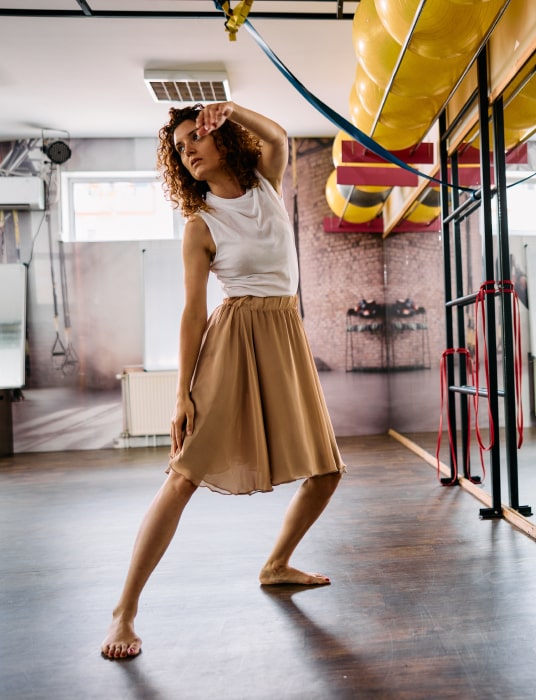 a girl dancing in a studio doing some dance steps