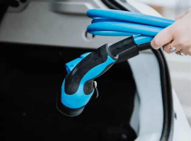 EV charging connector being plugged in