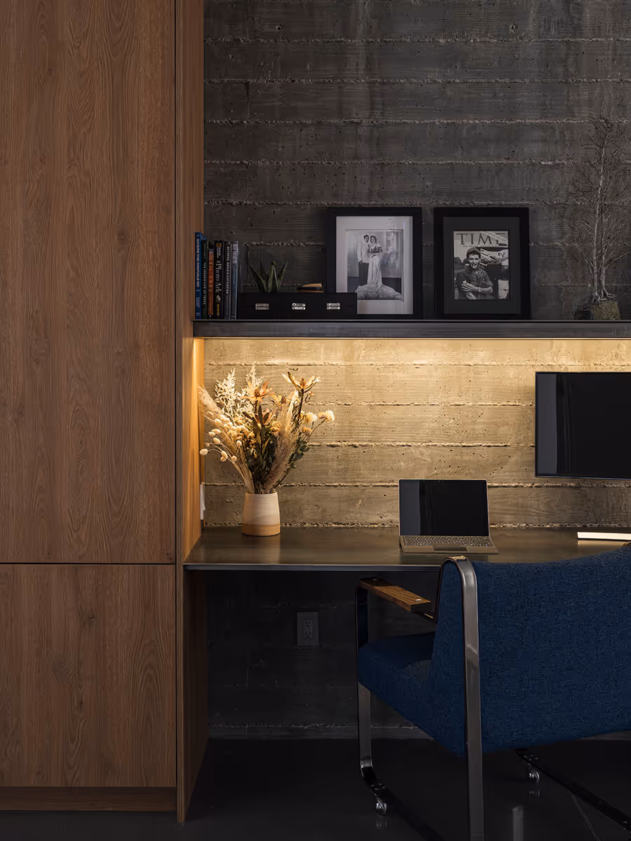boardformed concrete wall with steel desk at a modern desert house in Phoenix by The Ranch Mine