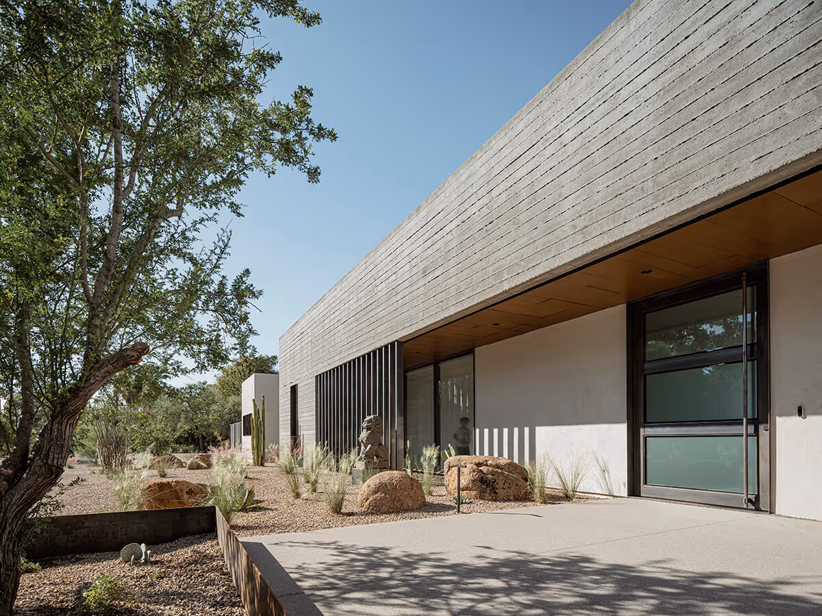 boardformed concrete and stucco modern desert house with a steel and glass pivot door  in Phoenix by The Ranch Mine