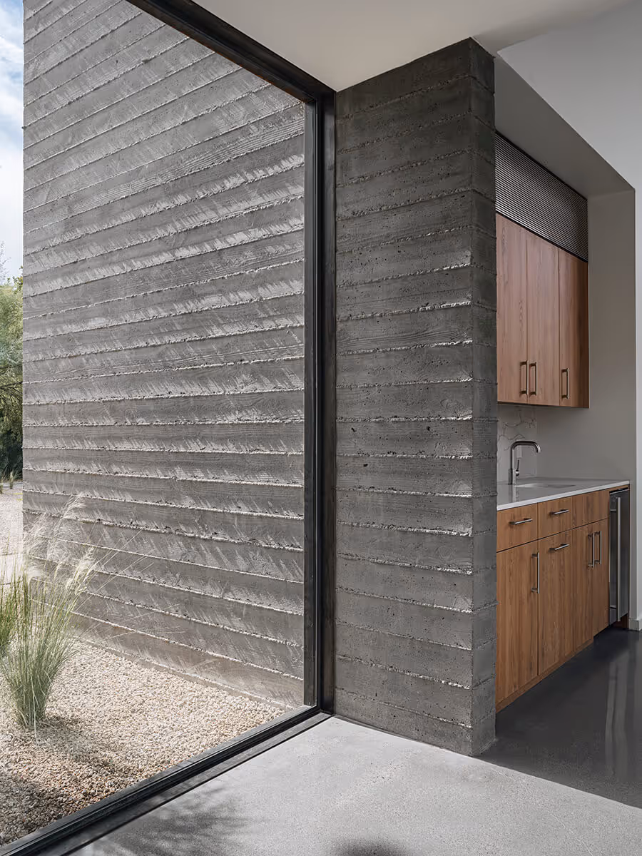 indoor outdoor boardformed concrete wall at a modern desert house in Phoenix by The Ranch Mine