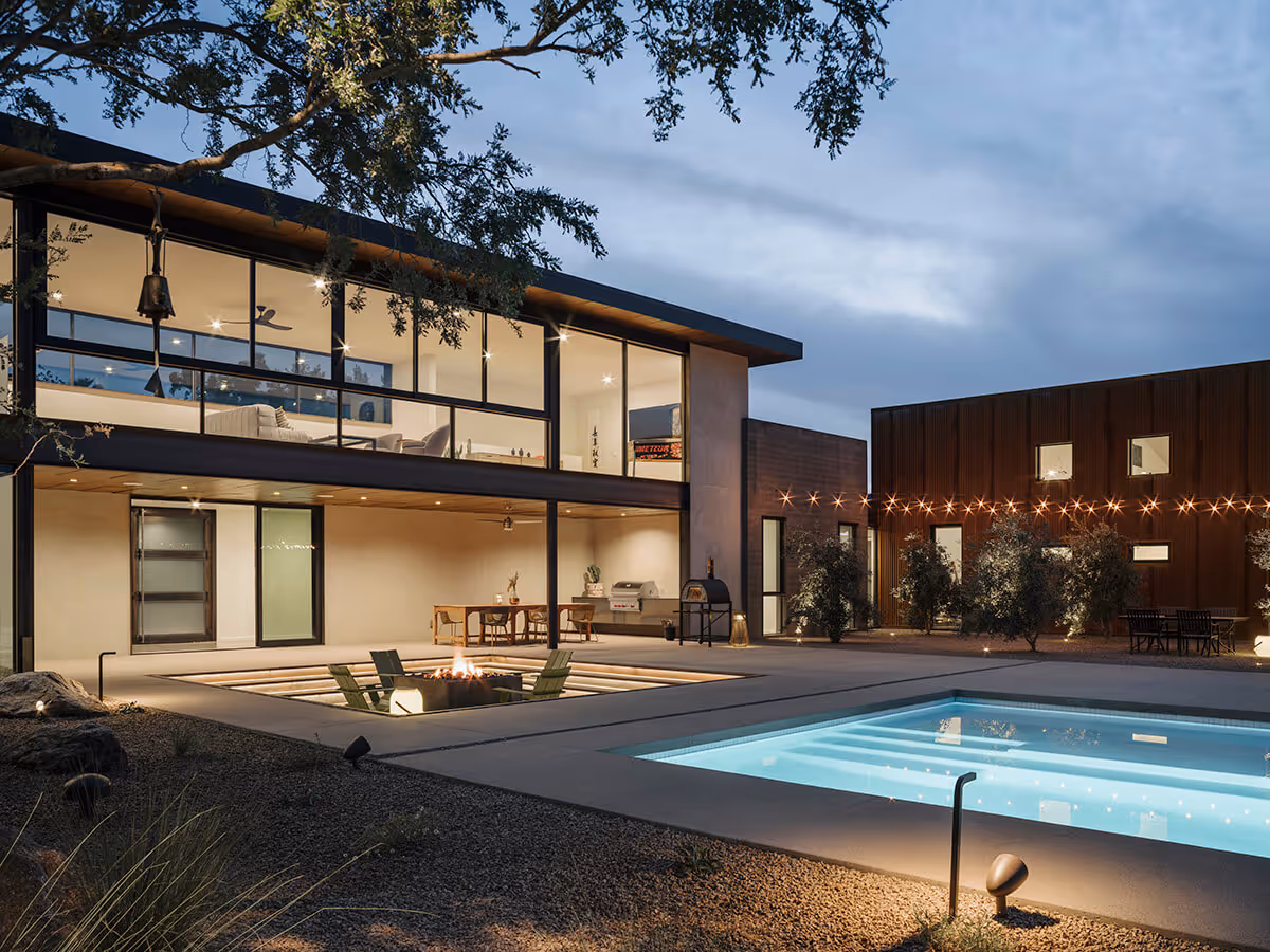 nighttime pool view and sunken firepit at a modern desert house in Phoenix by The Ranch Mine