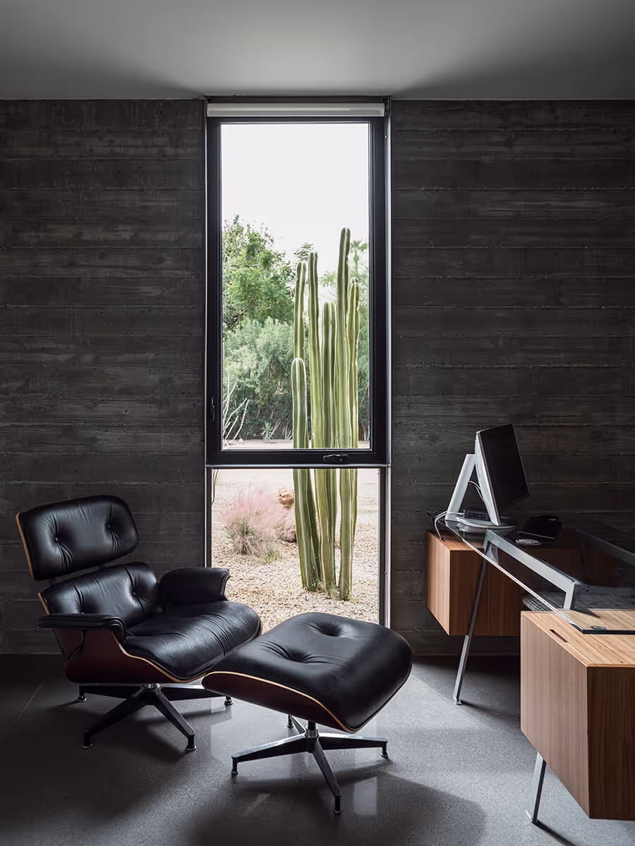 boardformed concrete wall in office with eames chair at a modern desert house in Phoenix by The Ranch Mine