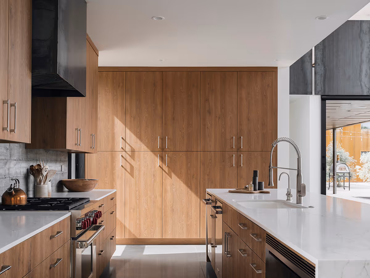 kitchen with steel hood and concrete wall at a modern desert house in Phoenix by The Ranch Mine