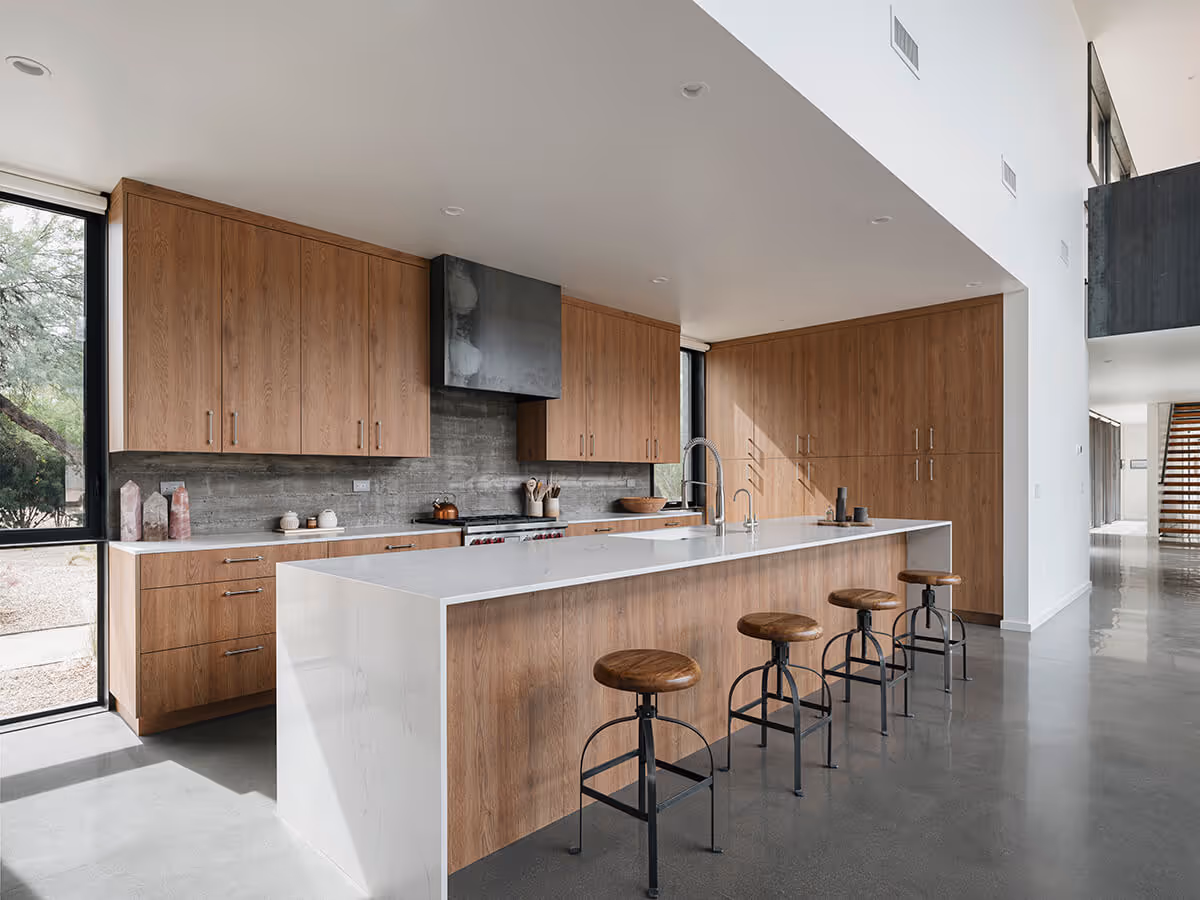 kitchen with steel hood and concrete wall at a modern desert house in Phoenix by The Ranch Mine