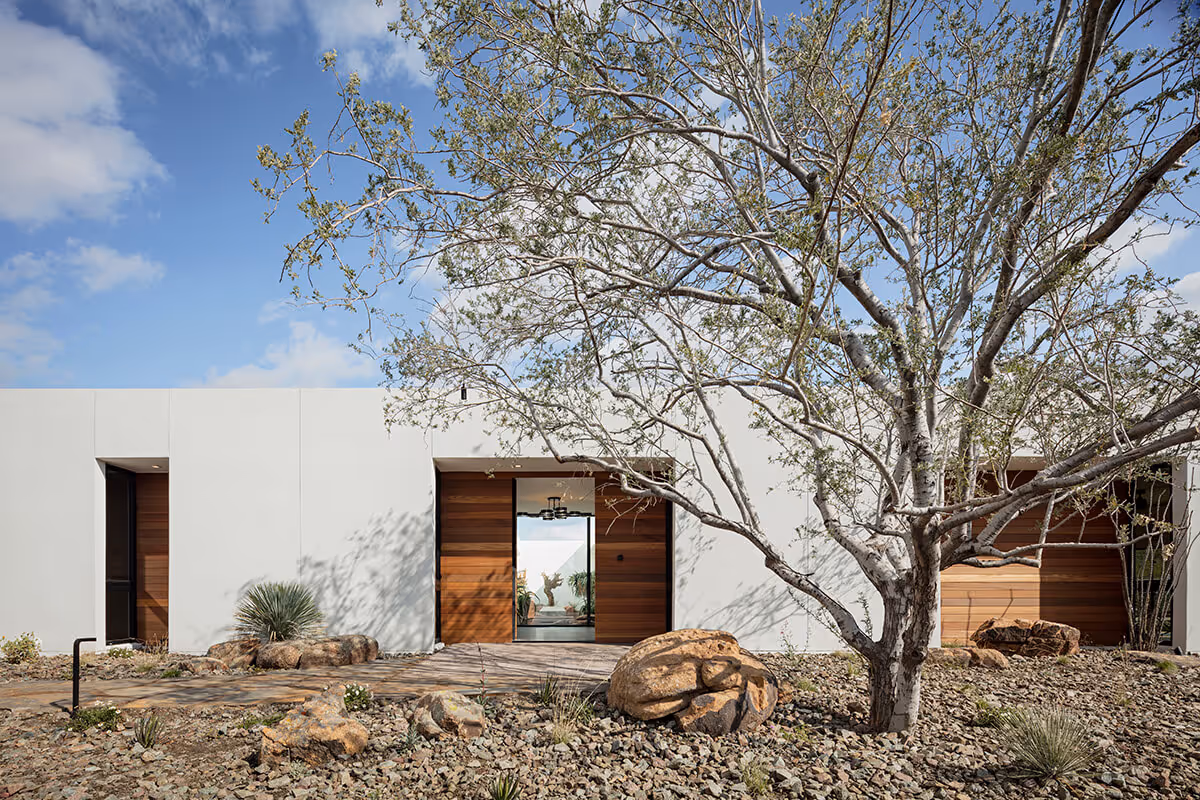 exterior with front door open of a modern desert house by The Ranch Mine