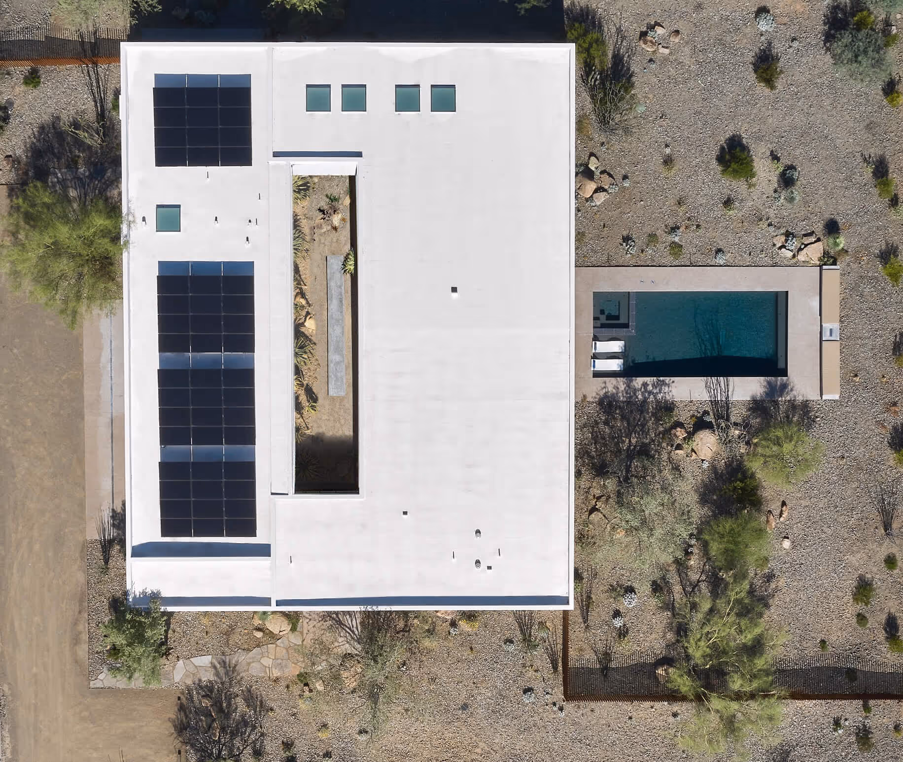 aerial view showing the Tesla solar panels that power the house, the courtyard and pool at a modern desert house by The Ranch Mine