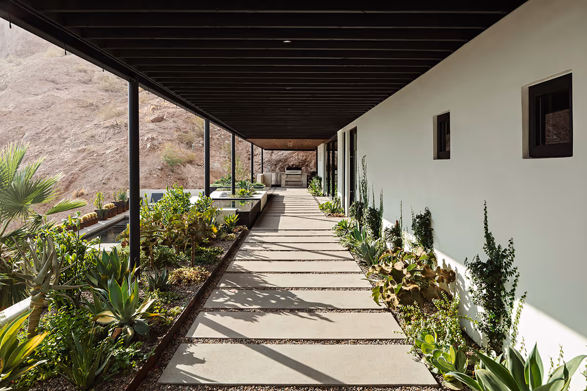 Covered walkway at a home renovation and addition transforming a Spanish Colonial Revival house into a modern mountainside home in Phoenix by The Ranch Mine