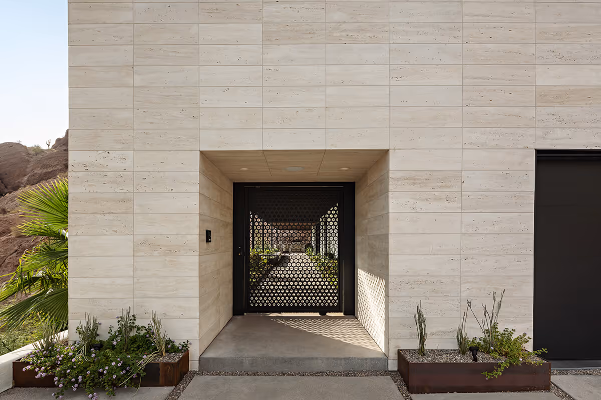 Front entry of a home renovation and addition transforming a Spanish Colonial Revival house into a modern mountainside home in Phoenix by The Ranch Mine