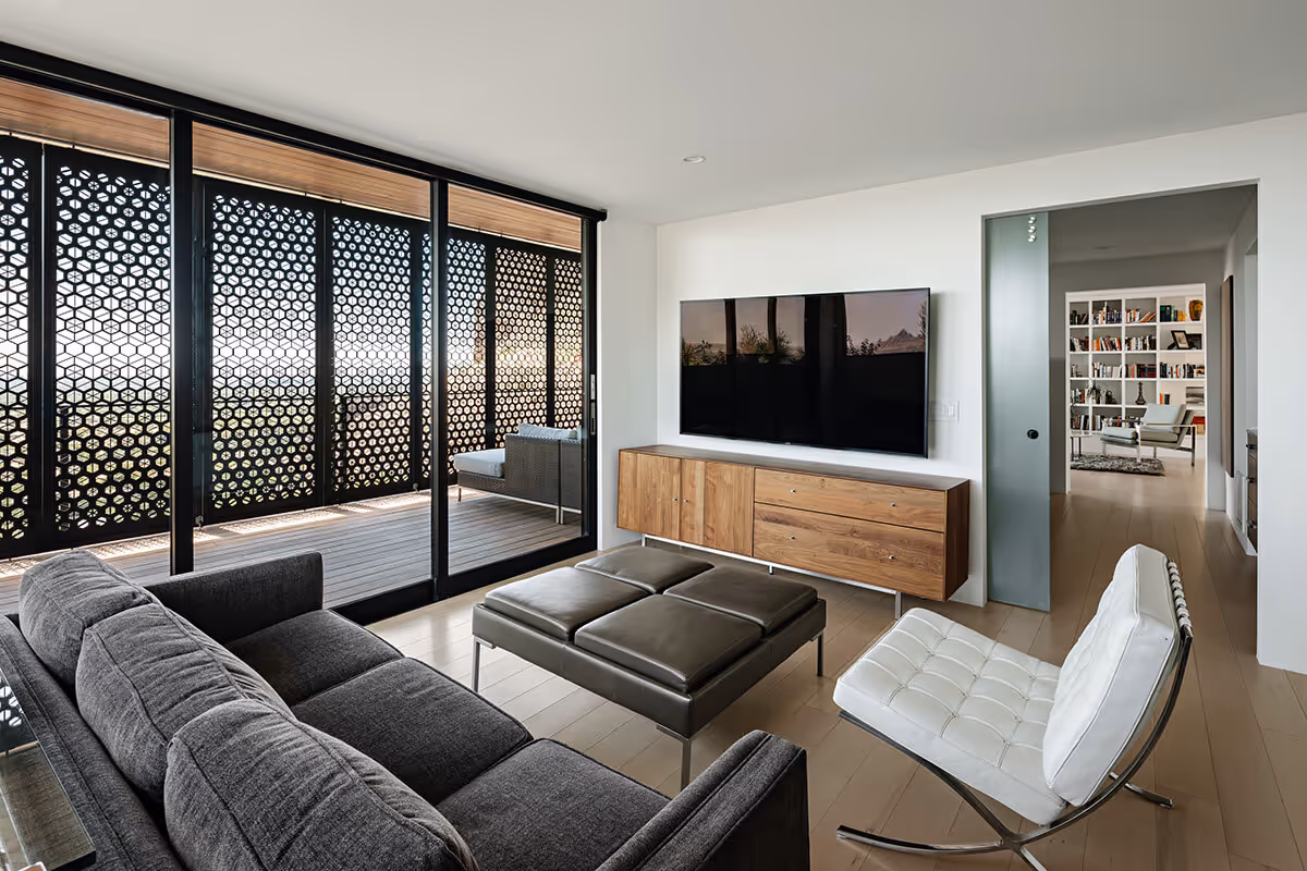 Primary bedroom sitting area with glass doors out to a sun screened patio at a modern home in Phoenix by The Ranch Mine