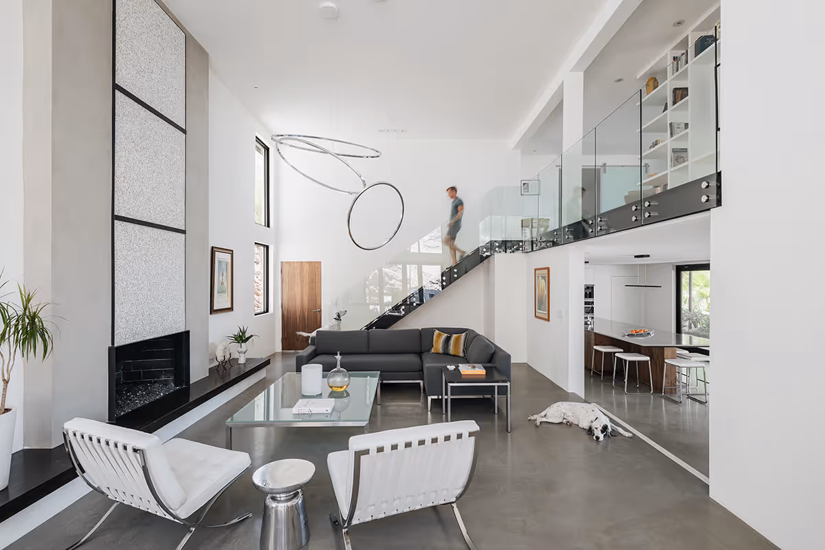 Living room with fireplace and glass stair at a modern home in Phoenix by The Ranch Mine