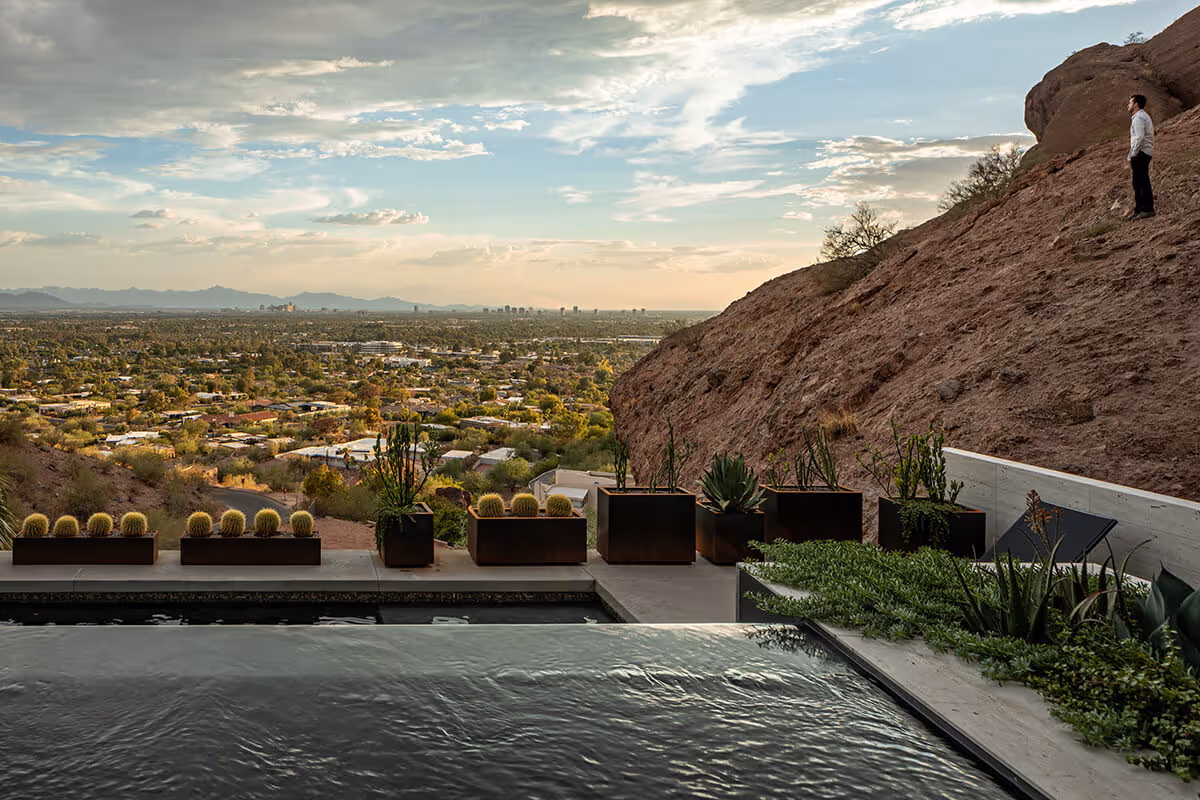 Infinity edge hot tub with a view of the Phoenix Skyline at a modern home in Phoenix by The Ranch Mine