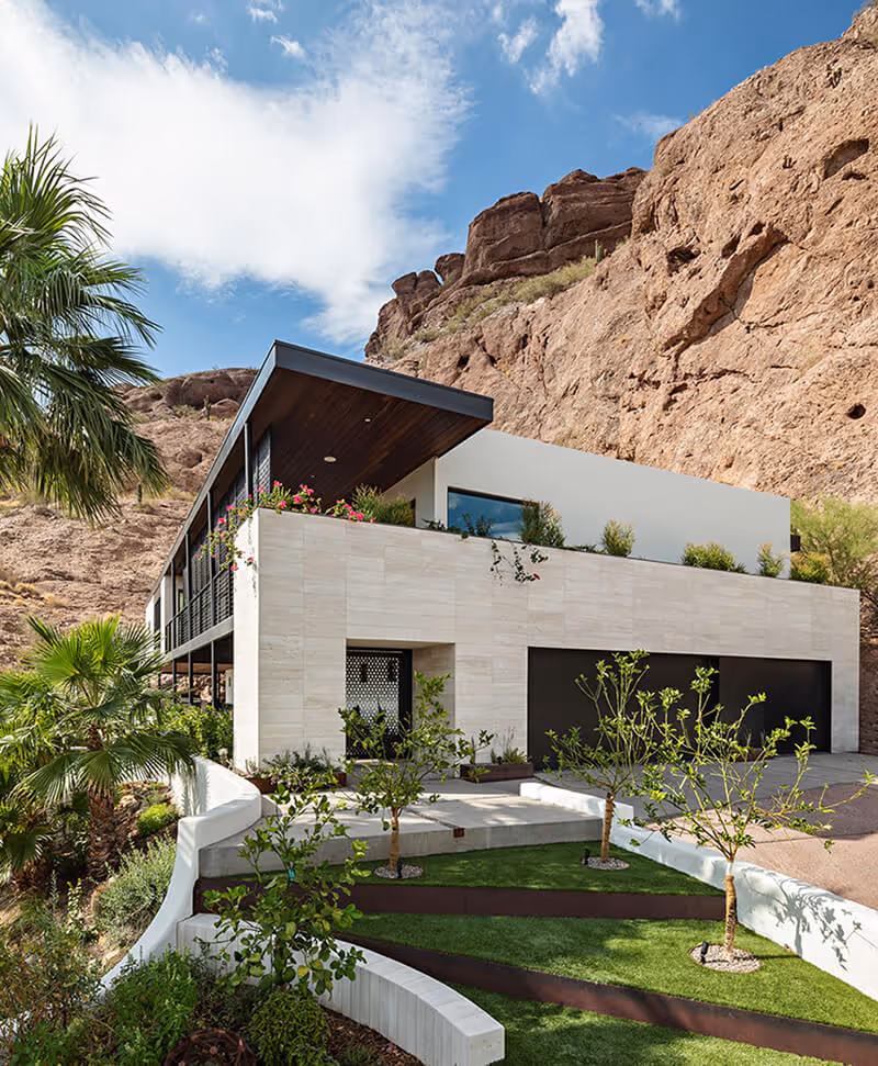 Front entry of a home renovation and addition transforming a Spanish Colonial Revival house into a modern mountainside home in Phoenix by The Ranch Mine
