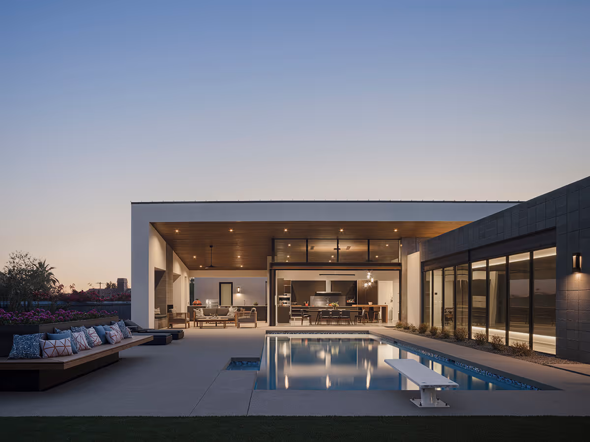 Night view of a pool with indoor outdoor living at a modern home in Phoenix by The Ranch Mine