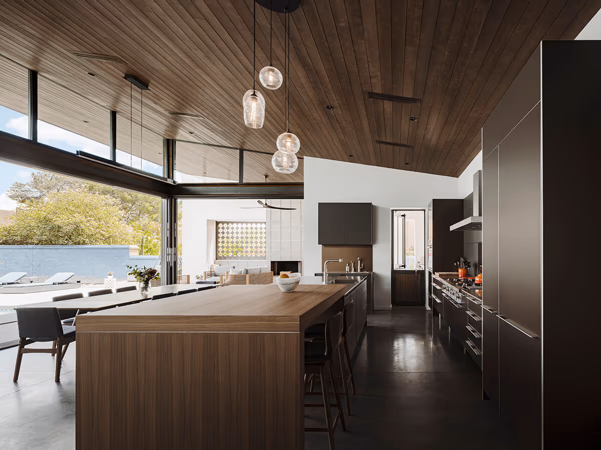 Kitchen and dining with a dark wood ceiling at a modern home in Phoenix by The Ranch Mine