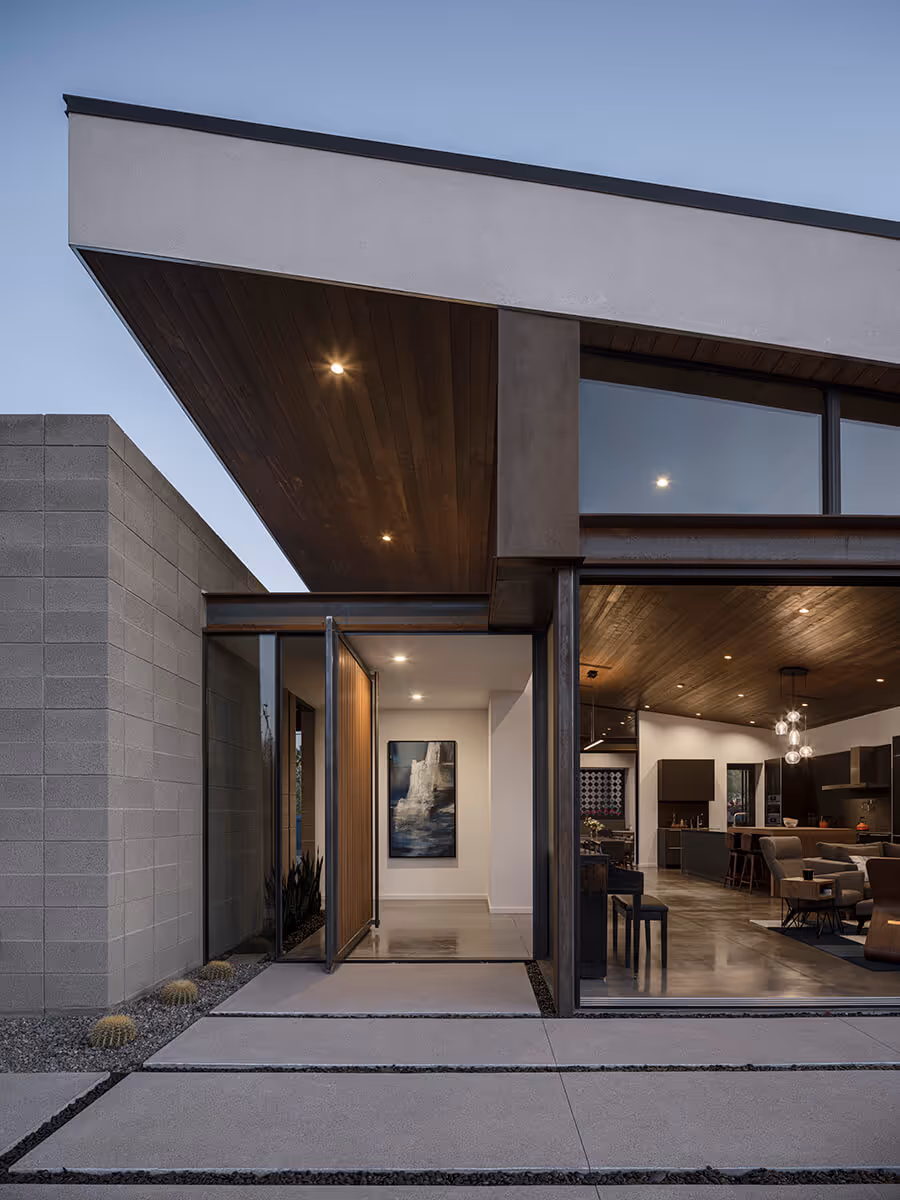 Night view of concrete block, steel and stucco modern home in Phoenix by The Ranch Mine
