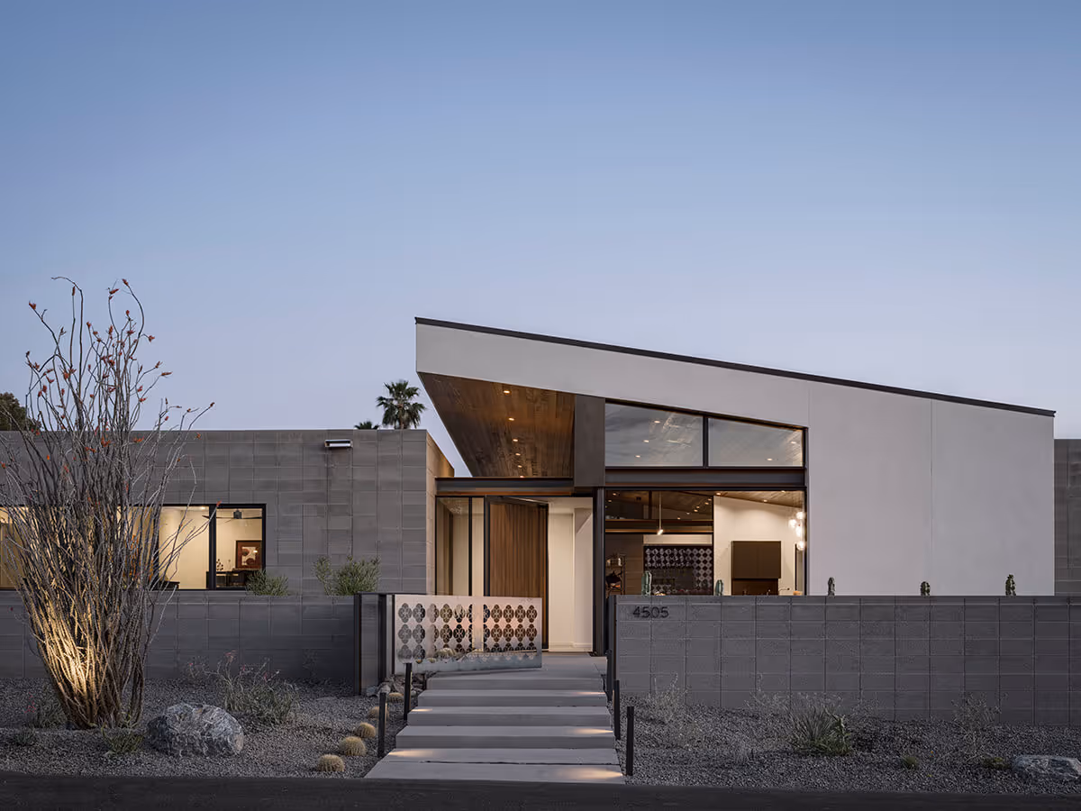 Night view of concrete block, steel and stucco modern home in Phoenix by The Ranch Mine