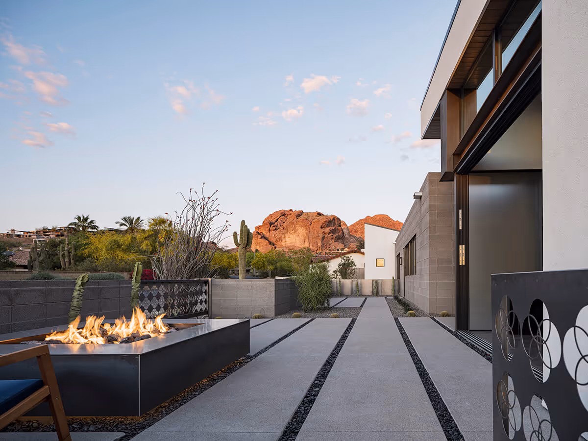 Dusk view of patio with fire pit with mountain view at a modern home in Phoenix by The Ranch Mine