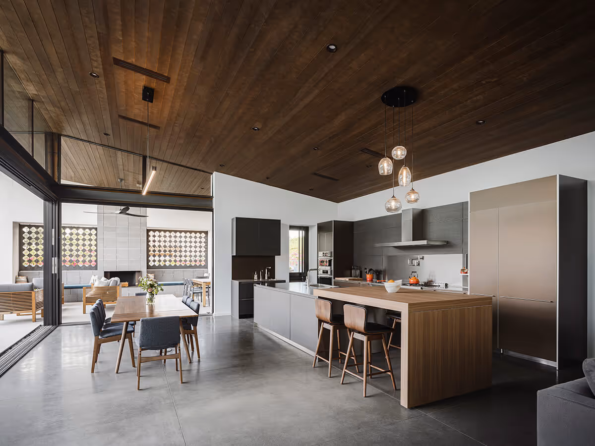 Kitchen and dining with a dark wood ceiling at a modern home in Phoenix by The Ranch Mine