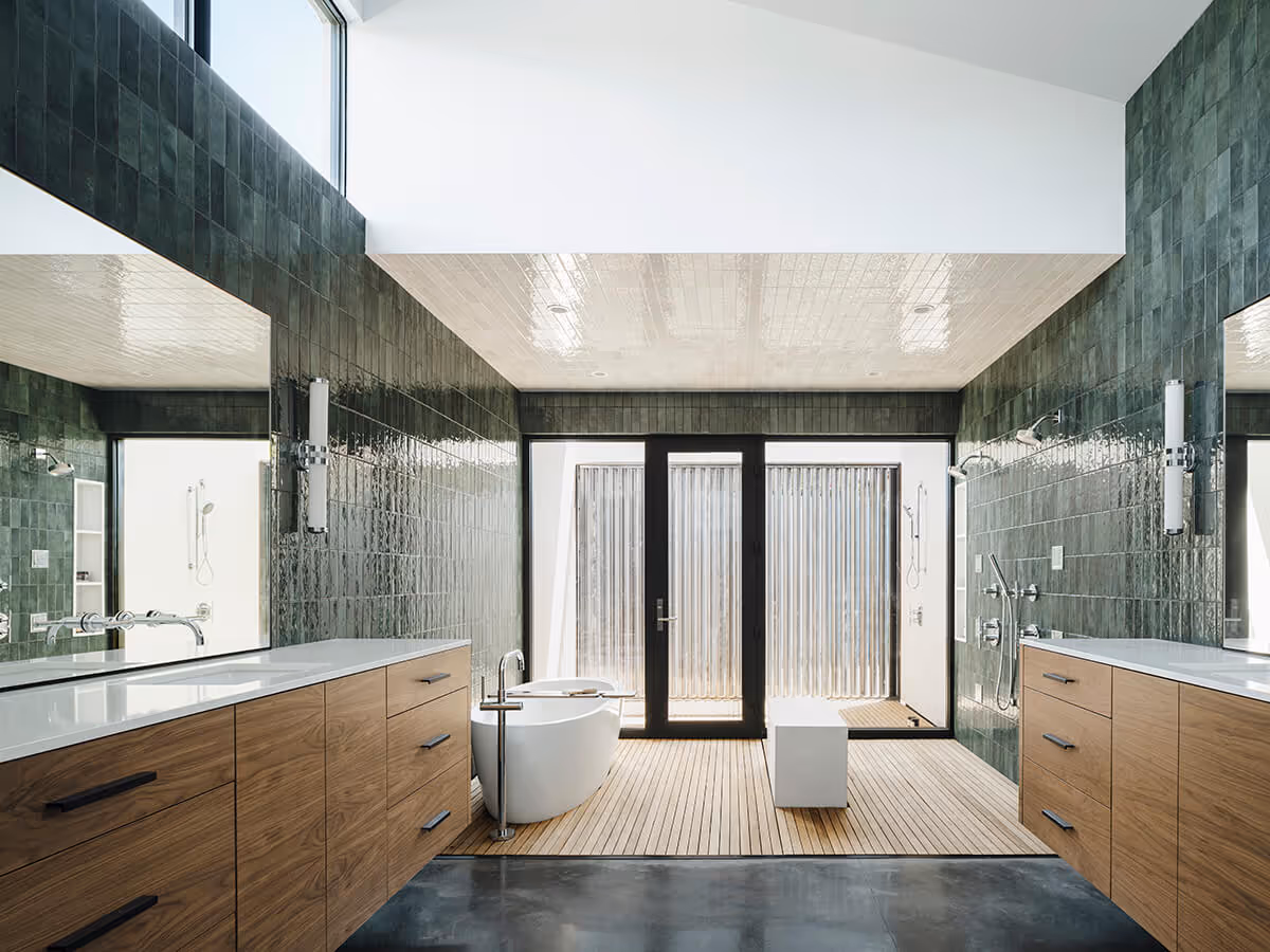 Wood vanity with concrete floor and wood floor with green tile at a modern home in Phoenix by The Ranch Mine