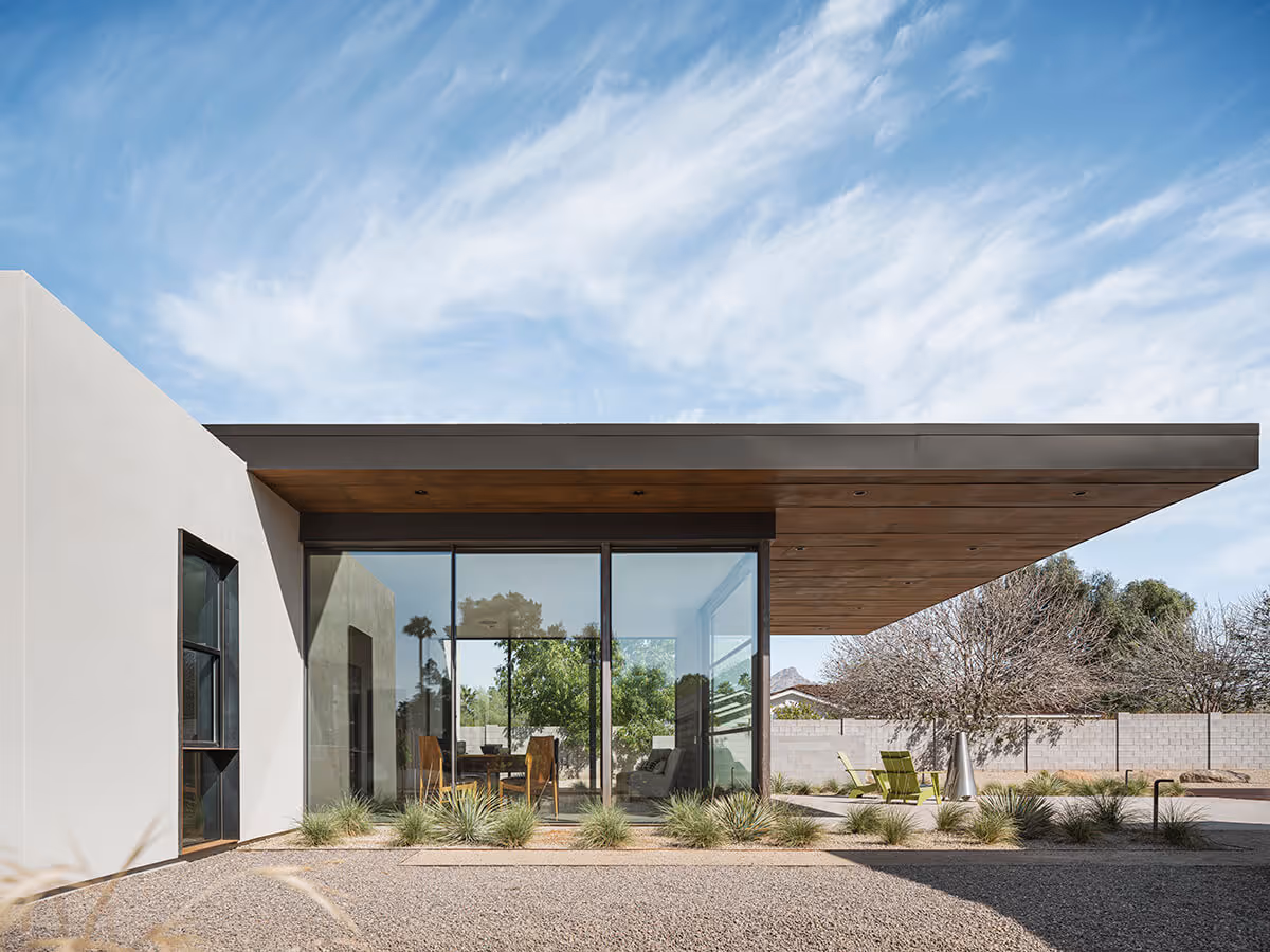 Floor to ceiling glass and a large cantilevered roof with wood ceiling on a casita in Phoenix by The Ranch Mine