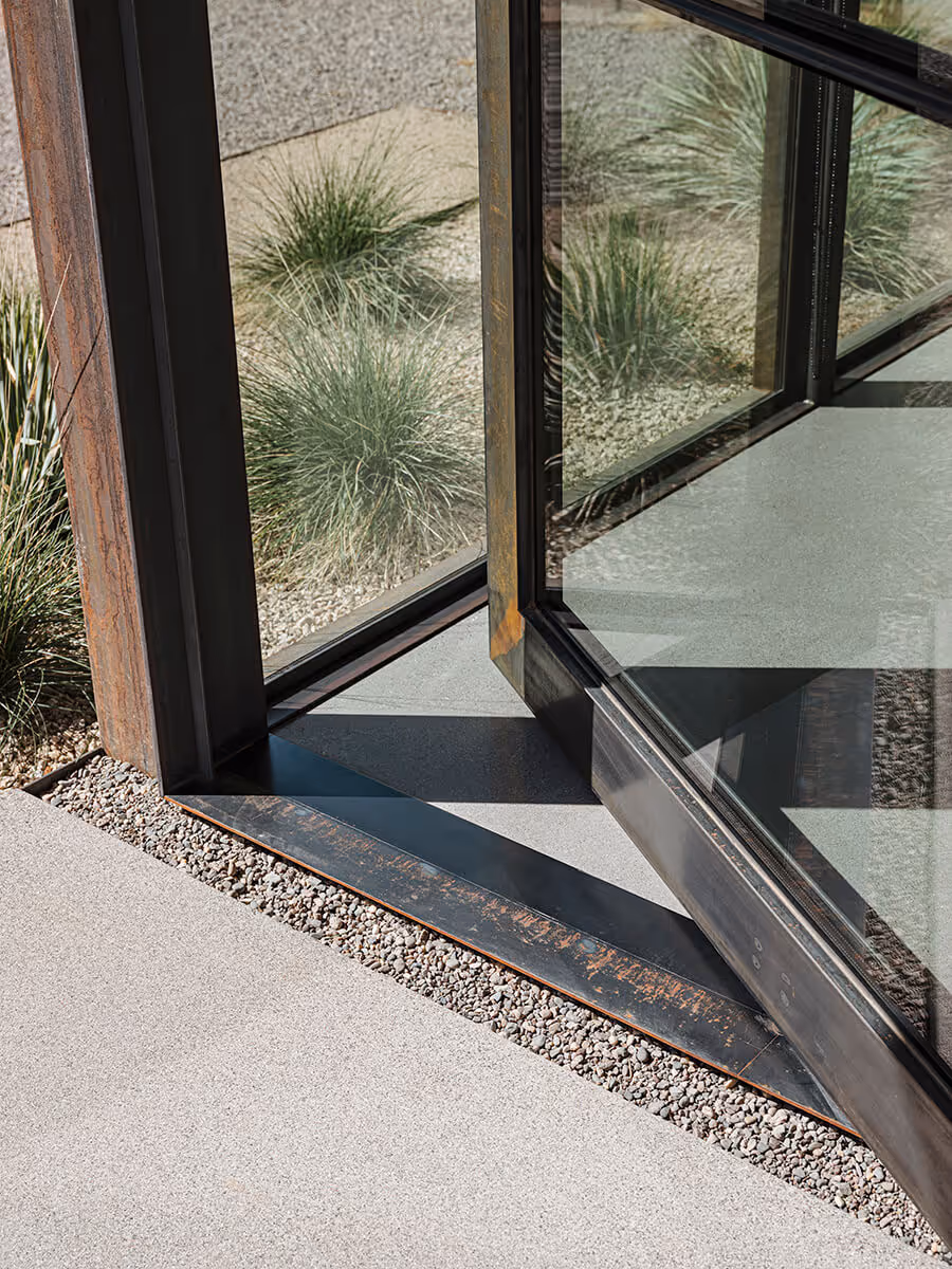 Huge steel and glass pivot door detail on a casita in Phoenix by The Ranch Mine